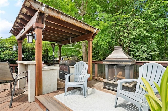 240 Emerald Crk W, Abita Springs, LA 70420 - wooden deck with exterior fireplace and exterior kitchen