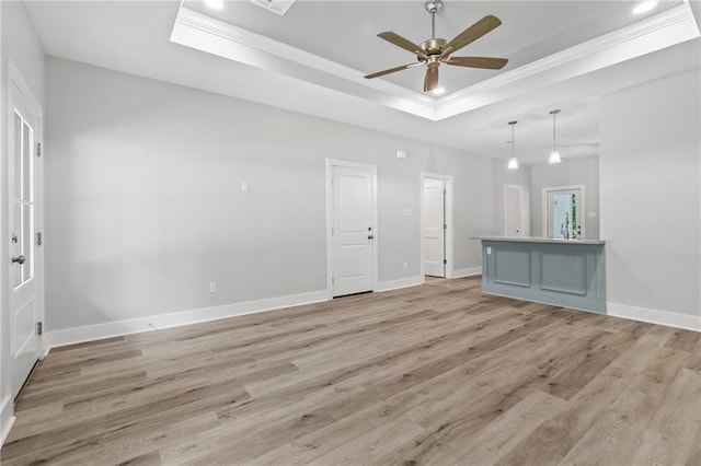 74446 Delta Ave, Covington, LA 70435 - unfurnished living room featuring a raised ceiling, crown molding, light wood-type flooring, a ceiling fan, and recessed lighting