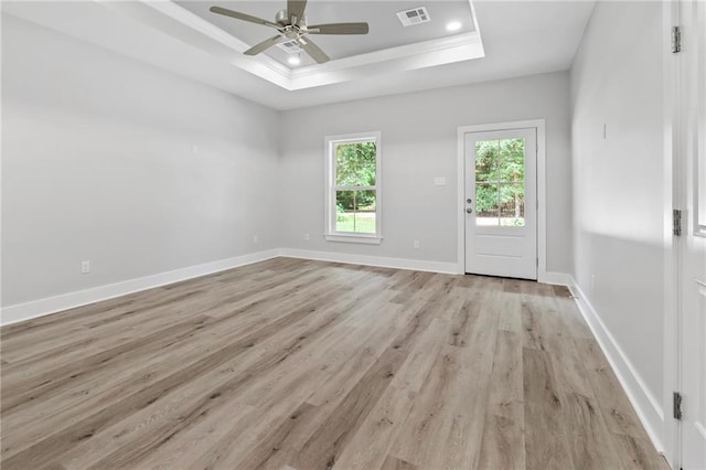 74446 Delta Ave, Covington, LA 70435 - empty room with light wood finished floors, a raised ceiling, ceiling fan, ornamental molding, and recessed lighting