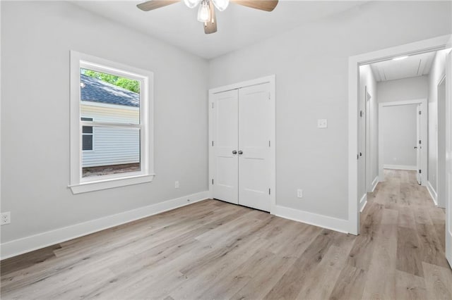 74446 Delta Ave, Covington, LA 70435 - unfurnished bedroom featuring attic access, light wood-style flooring, a closet, and a ceiling fan
