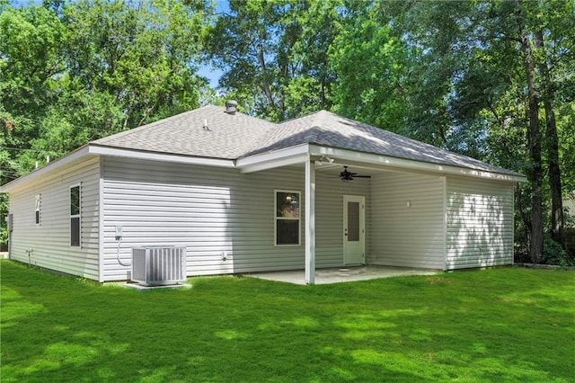 74446 Delta Ave, Covington, LA 70435 - rear view of house featuring a ceiling fan, a yard, a patio area, and a shingled roof