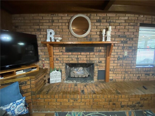 74258 N River Rd, Kentwood, LA 70444 - unfurnished living room featuring a fireplace and beamed ceiling