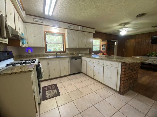 74258 N River Rd, Kentwood, LA 70444 - kitchen featuring stainless steel dishwasher, range with gas cooktop, a peninsula, a textured ceiling, and healthy amount of natural light
