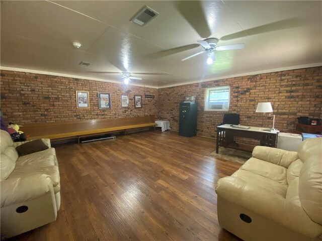 74258 N River Rd, Kentwood, LA 70444 - living room featuring brick wall, a ceiling fan, and wood finished floors
