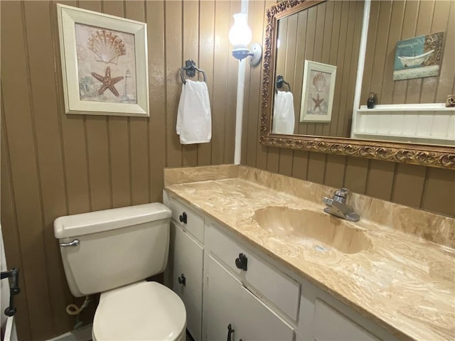 74258 N River Rd, Kentwood, LA 70444 - bathroom with vanity, a decorative wall, and wooden walls