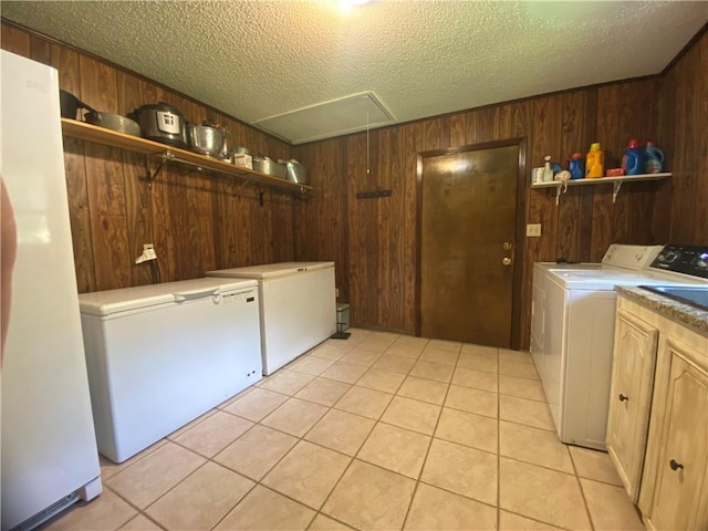 74258 N River Rd, Kentwood, LA 70444 - laundry area with attic access, separate washer and dryer, wood walls, cabinet space, and light tile patterned floors