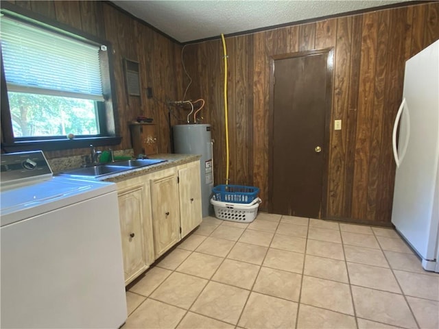 74258 N River Rd, Kentwood, LA 70444 - washroom featuring washer / clothes dryer, cabinet space, water heater, wooden walls, and light tile patterned floors