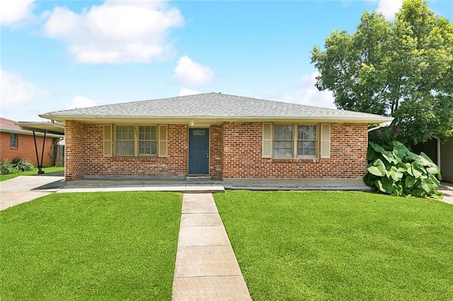 6501 Lafreniere St, Metairie, LA 70003 - view of front facade with a front yard, brick siding, and roof with shingles
