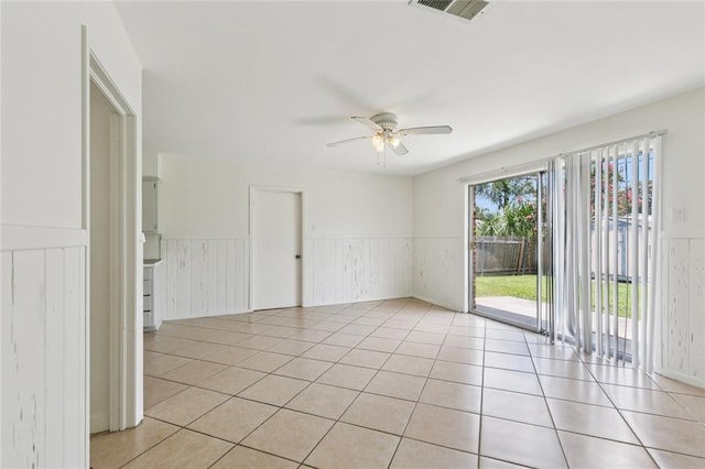 6501 Lafreniere St, Metairie, LA 70003 - spare room featuring a wainscoted wall, ceiling fan, and light tile patterned flooring