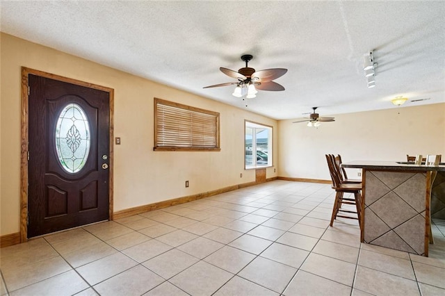 41 Camellia Ln, Waggaman, LA 70094 - entryway featuring a textured ceiling, ceiling fan, rail lighting, and light tile patterned floors