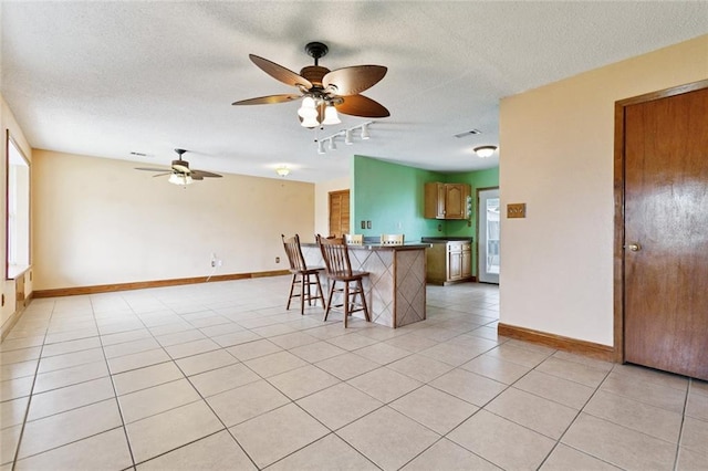 41 Camellia Ln, Waggaman, LA 70094 - kitchen featuring a kitchen breakfast bar, a ceiling fan, track lighting, a textured ceiling, and dark countertops