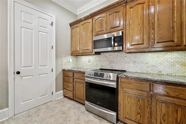 1633 First St Unit 201, New Orleans, LA 70130 - kitchen featuring appliances with stainless steel finishes, dark stone counters, crown molding, backsplash, and brown cabinets