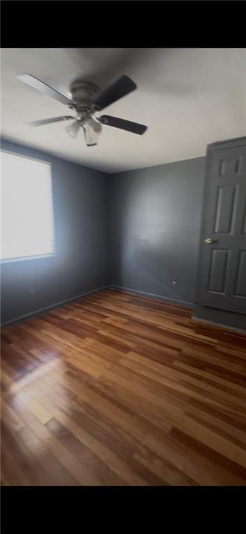 2006 Clouet St, New Orleans, LA 70117 - empty room with wood finished floors and ceiling fan