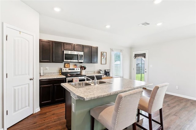 42310 Andrea Ln, Ponchatoula, LA 70454 - kitchen featuring stainless steel appliances, a kitchen breakfast bar, dark wood finished floors, light countertops, and recessed lighting