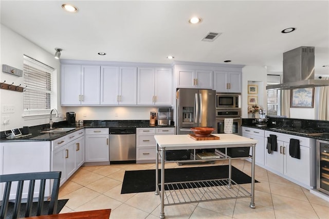 6910 General Diaz St, New Orleans, LA 70124 - kitchen with appliances with stainless steel finishes, plenty of natural light, island exhaust hood, recessed lighting, and light tile patterned flooring