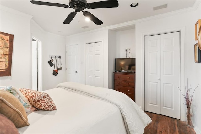6910 General Diaz St, New Orleans, LA 70124 - bedroom featuring two closets, dark wood finished floors, crown molding, ceiling fan, and recessed lighting