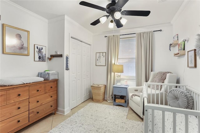 6910 General Diaz St, New Orleans, LA 70124 - bedroom with light tile patterned flooring, ornamental molding, a crib, a closet, and ceiling fan
