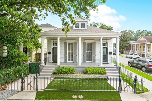 4532-34 Chestnut St, New Orleans, LA 70115 - view of front of property featuring a gate, a porch, a fenced front yard, and a shingled roof
