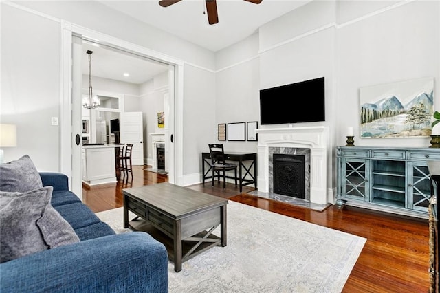 4532-34 Chestnut St, New Orleans, LA 70115 - living area with a premium fireplace, a ceiling fan, wood finished floors, and a chandelier