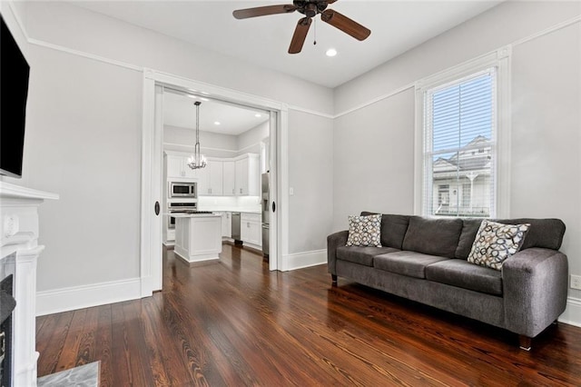 4532-34 Chestnut St, New Orleans, LA 70115 - living room featuring a ceiling fan, a fireplace, dark wood finished floors, a chandelier, and recessed lighting