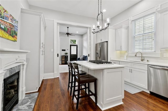 4532-34 Chestnut St, New Orleans, LA 70115 - kitchen featuring stainless steel appliances, a center island, dark wood-style flooring, a breakfast bar, and white cabinets