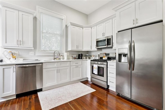 4532-34 Chestnut St, New Orleans, LA 70115 - kitchen with appliances with stainless steel finishes, white cabinetry, light countertops, and dark wood-type flooring