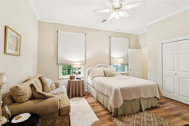 19632 Carol Morgan Rd, Franklinton, LA 70438 - bedroom featuring light wood finished floors, crown molding, a ceiling fan, and a closet
