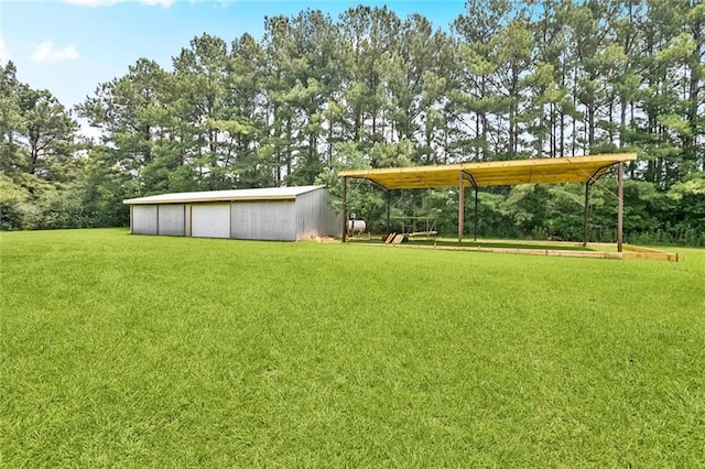 19632 Carol Morgan Rd, Franklinton, LA 70438 - view of green lawn with a detached garage, an outbuilding, and view of scattered trees