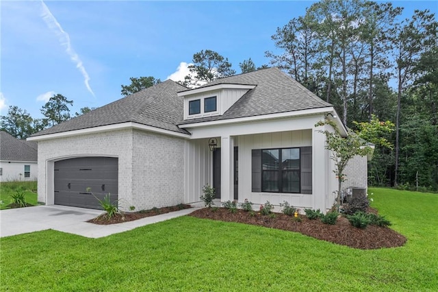 1169 Fox Sparrow Loop, Madisonville, LA 70447 - view of front of property featuring driveway, an attached garage, a front yard, board and batten siding, and roof with shingles