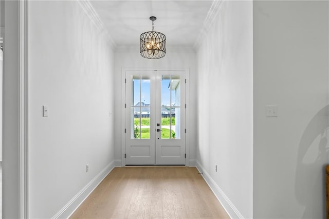 1169 Fox Sparrow Loop, Madisonville, LA 70447 - doorway to outside with light wood finished floors, a chandelier, french doors, and crown molding