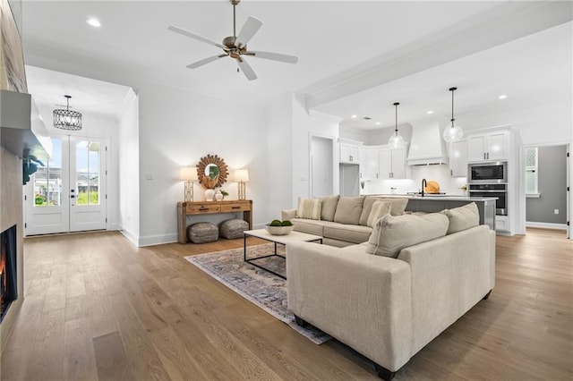 1169 Fox Sparrow Loop, Madisonville, LA 70447 - living room with recessed lighting, crown molding, wood finished floors, a ceiling fan, and french doors
