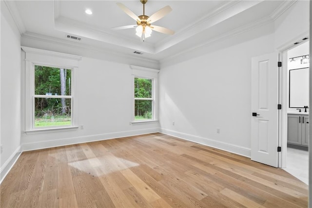 1169 Fox Sparrow Loop, Madisonville, LA 70447 - unfurnished room with light wood finished floors, crown molding, a tray ceiling, and a ceiling fan