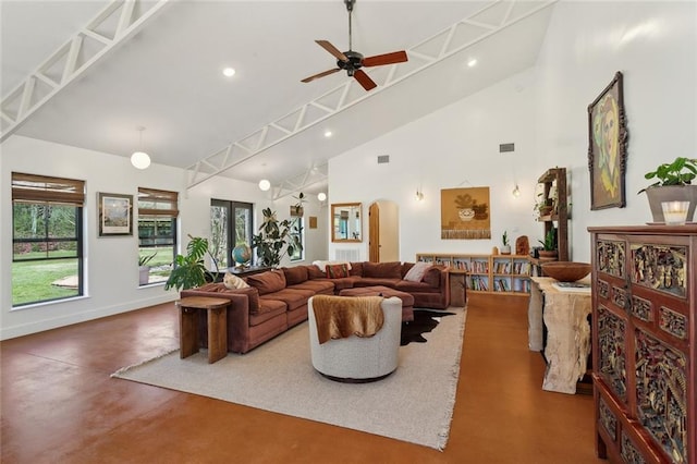 80695 Bob Baxter Rd, Bush, LA 70431 - living area featuring finished concrete floors, high vaulted ceiling, a ceiling fan, healthy amount of natural light, and arched walkways