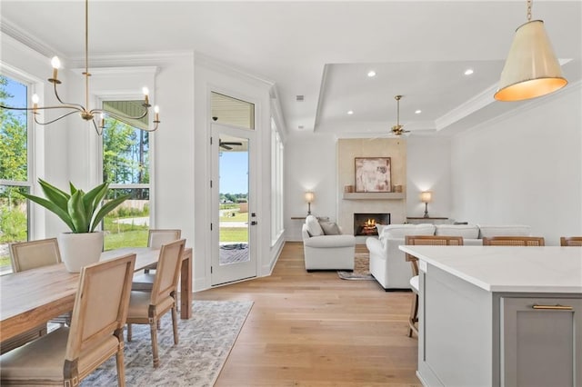 4141 Endor Loop, Mandeville, LA 70448 - dining space with light wood-style flooring, crown molding, a ceiling fan, plenty of natural light, and a raised ceiling
