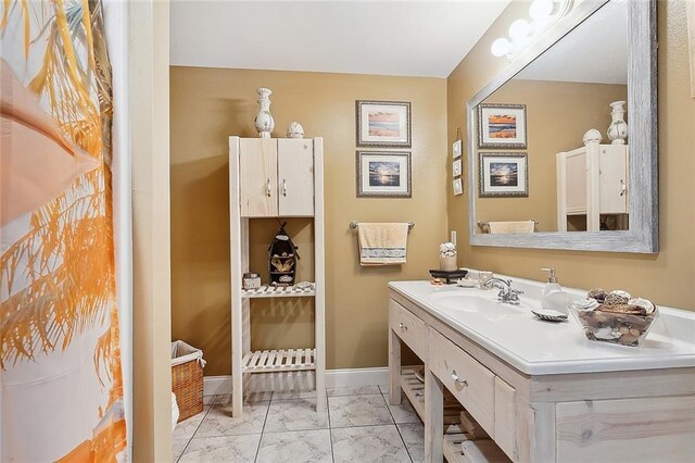 1944 Magnolia St, Lafitte, LA 70067 - bathroom featuring marble finish flooring and vanity