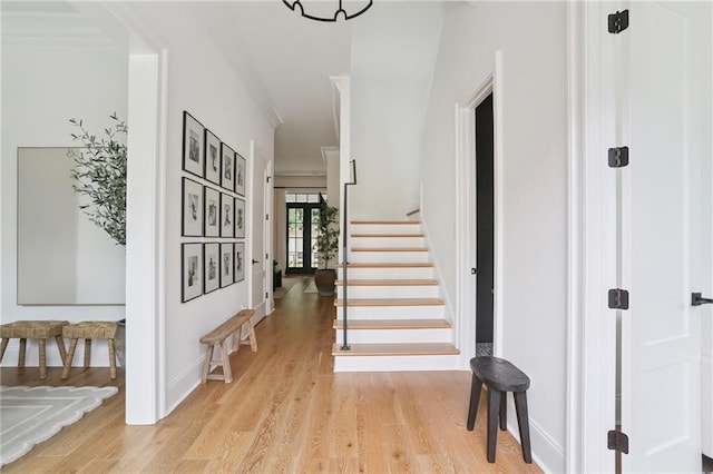 303 W William David Pkwy, Metairie, LA 70005 - entrance foyer with stairway, light wood-style floors, and crown molding