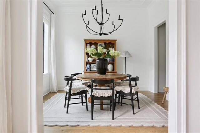 303 W William David Pkwy, Metairie, LA 70005 - dining space featuring a chandelier, wood finished floors, and ornamental molding