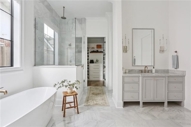 303 W William David Pkwy, Metairie, LA 70005 - bathroom with a marble finish shower, a spacious closet, a soaking tub, vanity, and marble finish floors