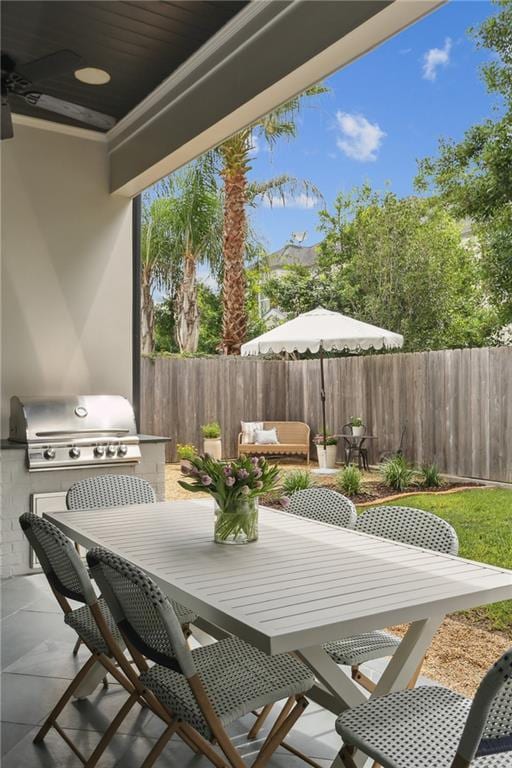 303 W William David Pkwy, Metairie, LA 70005 - fenced backyard featuring area for grilling, outdoor dining area, and a patio