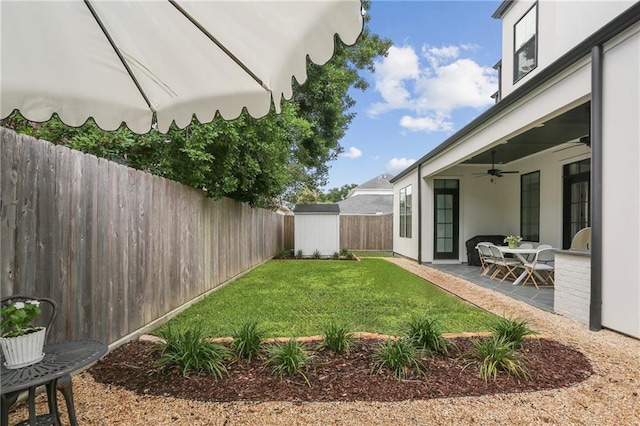 303 W William David Pkwy, Metairie, LA 70005 - fenced backyard with a ceiling fan, a storage shed, and a patio area