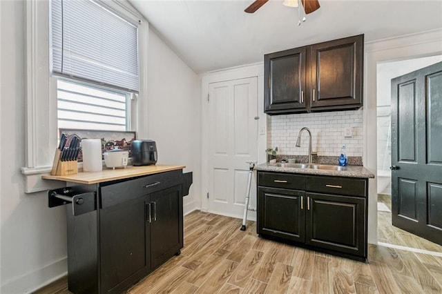 112830 N Roman St, New Orleans, LA 70116 - kitchen featuring backsplash, a ceiling fan, light wood-type flooring, and light countertops
