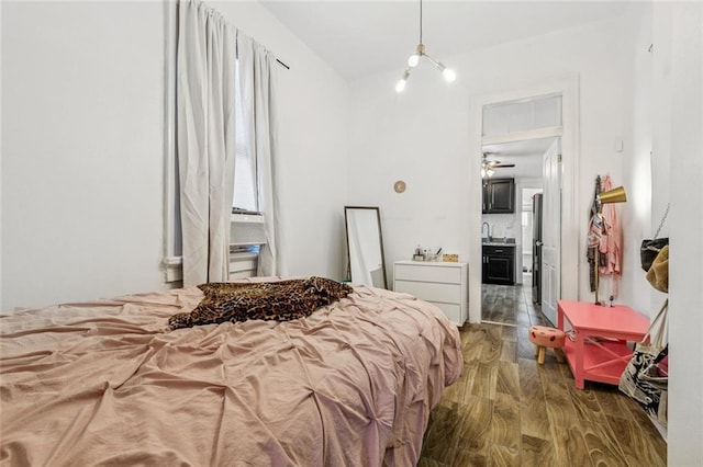 112830 N Roman St, New Orleans, LA 70116 - bedroom featuring wood finished floors and connected bathroom