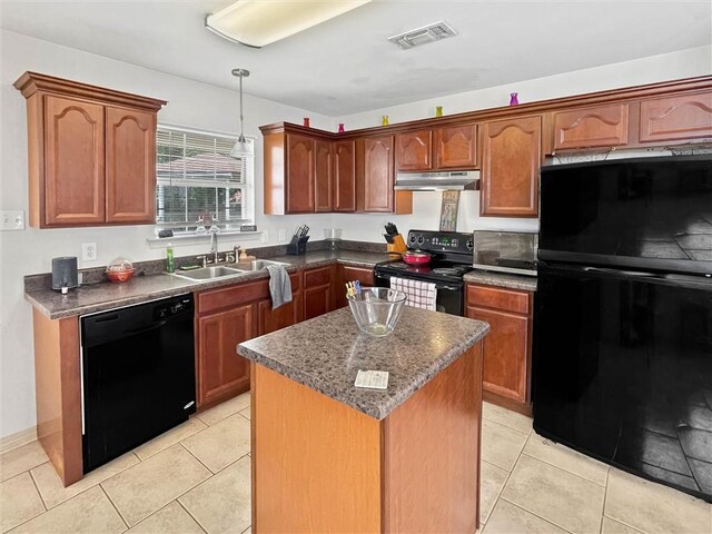 2411 Jay St, Slidell, LA 70460 - kitchen featuring black appliances, under cabinet range hood, a center island, dark countertops, and hanging light fixtures