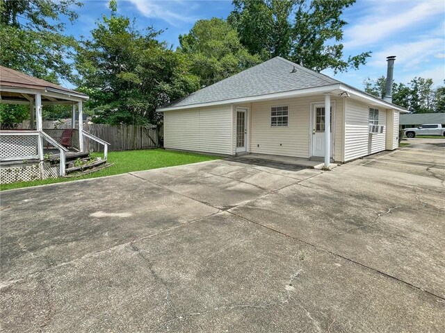 2411 Jay St, Slidell, LA 70460 - rear view of house featuring a patio area, a shingled roof, and driveway