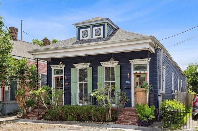 820-22 N Salcedo St, New Orleans, LA 70119 - view of front of home with a porch, roof with shingles, and cooling unit