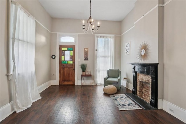 820-22 N Salcedo St, New Orleans, LA 70119 - entryway featuring a fireplace with raised hearth, hardwood / wood-style floors, and a chandelier