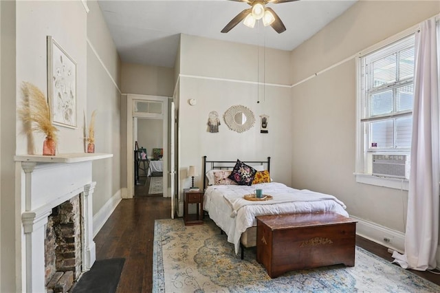 820-22 N Salcedo St, New Orleans, LA 70119 - bedroom featuring wood finished floors, cooling unit, a fireplace, and a ceiling fan