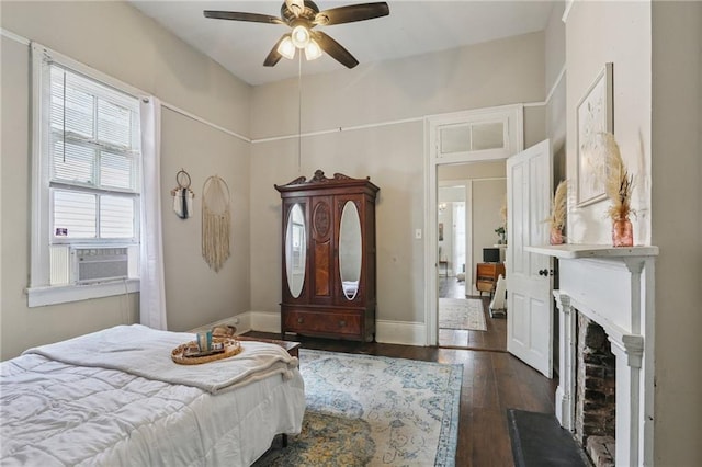 820-22 N Salcedo St, New Orleans, LA 70119 - bedroom with cooling unit, dark wood-style flooring, a fireplace, and ceiling fan
