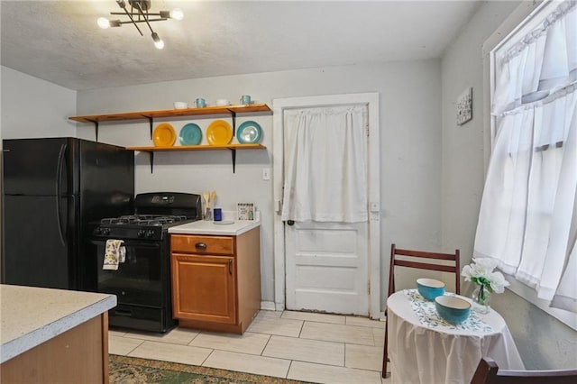 820-22 N Salcedo St, New Orleans, LA 70119 - kitchen with black appliances, light countertops, brown cabinets, and open shelves
