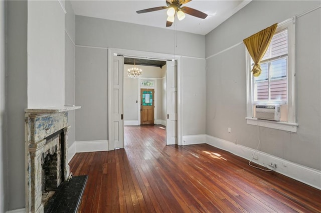 820-22 N Salcedo St, New Orleans, LA 70119 - unfurnished living room featuring a ceiling fan, wood-type flooring, a chandelier, and a fireplace with raised hearth